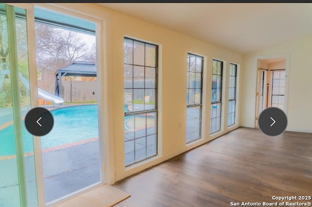 entryway featuring lofted ceiling and wood finished floors