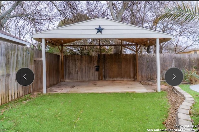 view of yard featuring a carport and fence