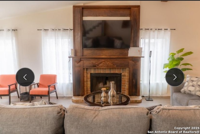 living area with a brick fireplace