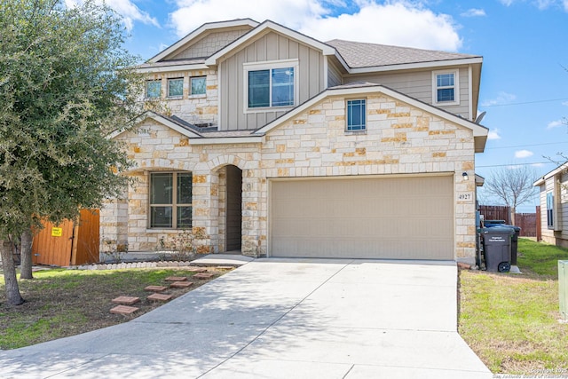 view of front of property featuring fence, board and batten siding, and concrete driveway