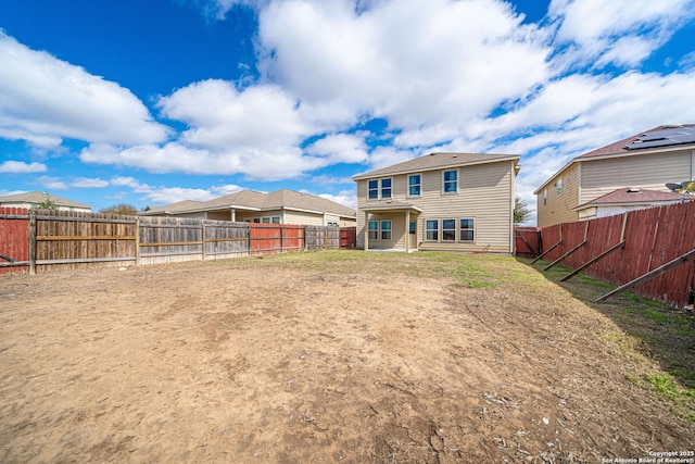 back of property with a fenced backyard