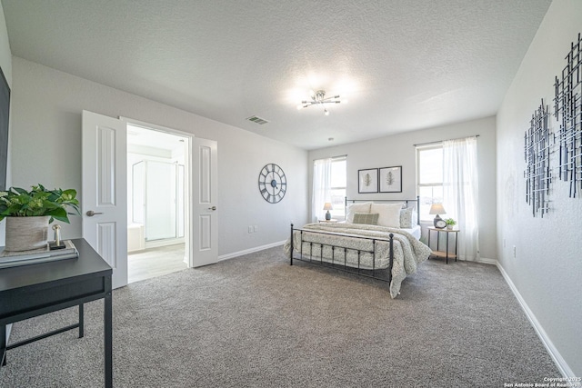 carpeted bedroom featuring a textured ceiling, visible vents, and baseboards