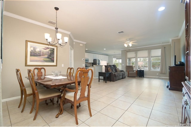 dining space featuring baseboards, crown molding, and light tile patterned flooring