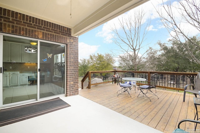 wooden deck featuring outdoor dining area