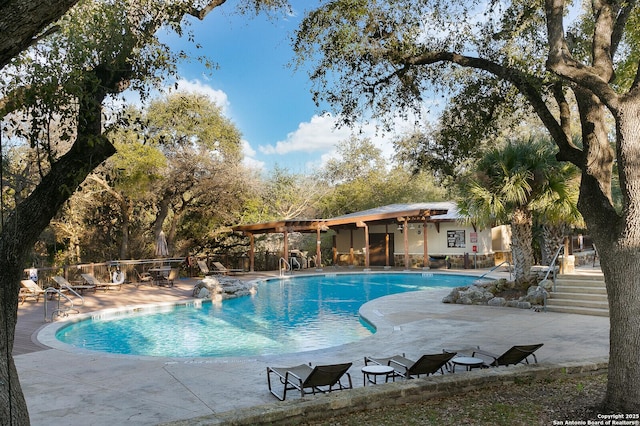 pool featuring fence and a patio