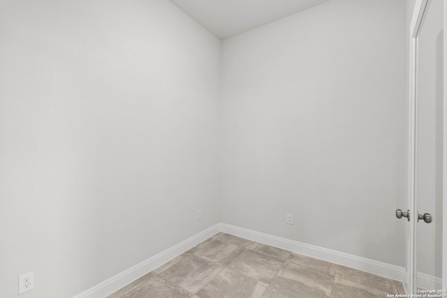 spare room featuring baseboards