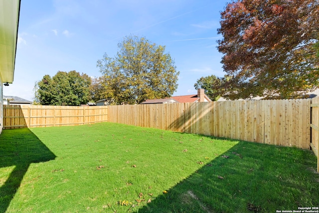 view of yard with a fenced backyard