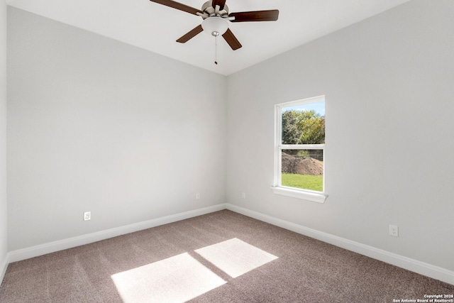 empty room with a ceiling fan, carpet flooring, and baseboards