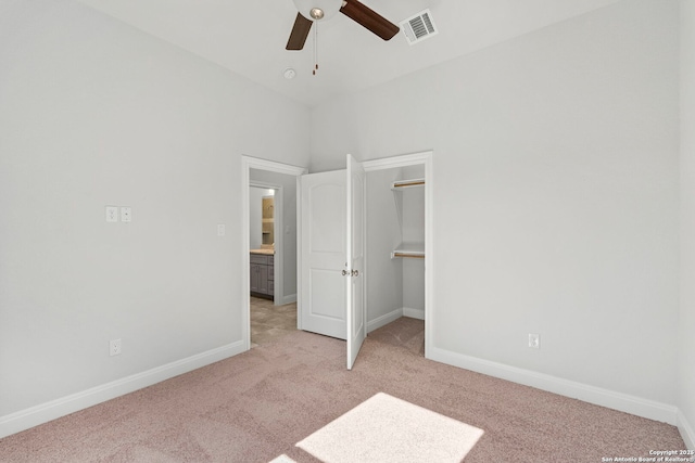 unfurnished bedroom with visible vents, light carpet, and baseboards