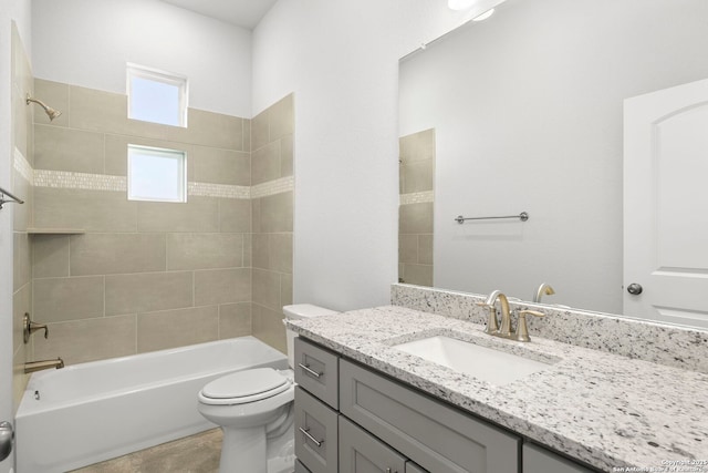 full bath featuring vanity, shower / tub combination, and toilet