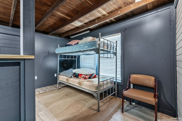 bedroom with wood ceiling, beam ceiling, and wood finished floors