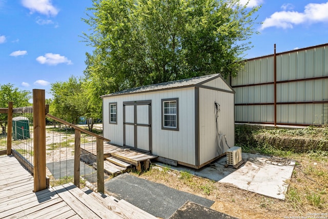 view of shed featuring fence