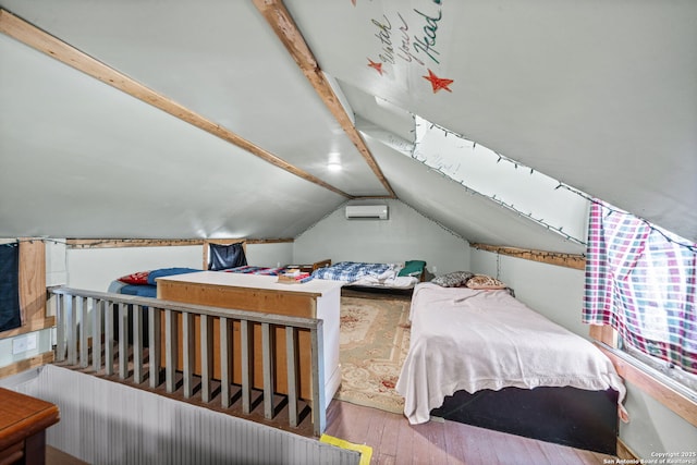 bedroom with vaulted ceiling with beams, a wall mounted AC, and wood finished floors