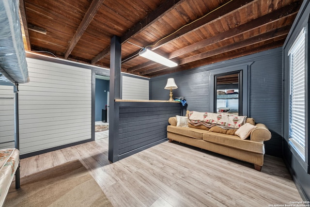 living room with light wood-style floors, wooden ceiling, and beam ceiling