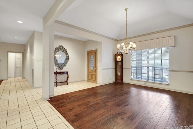 unfurnished room featuring light wood finished floors, baseboards, vaulted ceiling, a chandelier, and recessed lighting