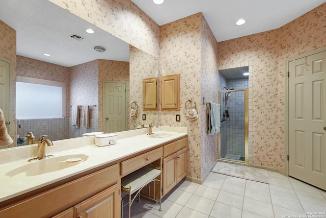 bathroom featuring a sink and wallpapered walls