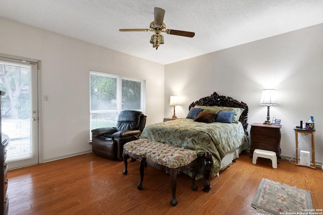 bedroom with access to exterior, ceiling fan, baseboards, and wood finished floors