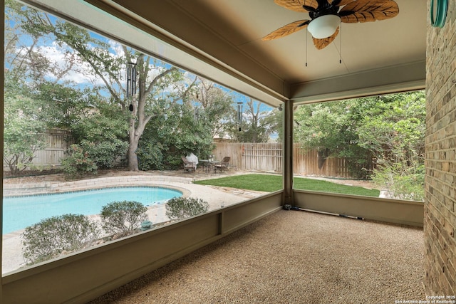 unfurnished sunroom with a ceiling fan