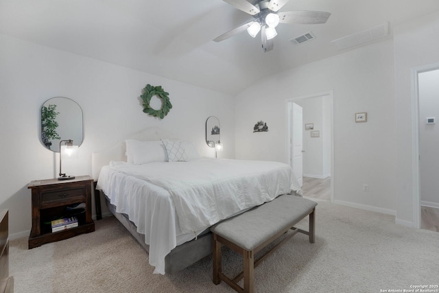 bedroom featuring visible vents, a ceiling fan, light carpet, vaulted ceiling, and baseboards