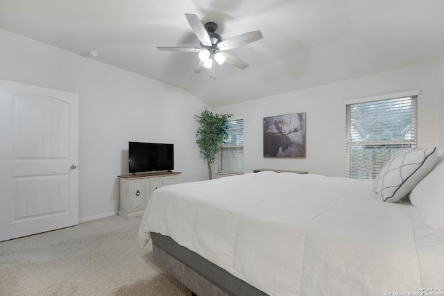 bedroom with ceiling fan, baseboards, vaulted ceiling, and light colored carpet