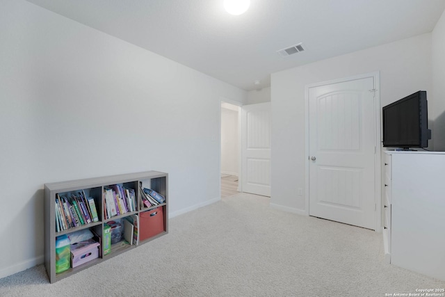 game room featuring baseboards, visible vents, and light colored carpet