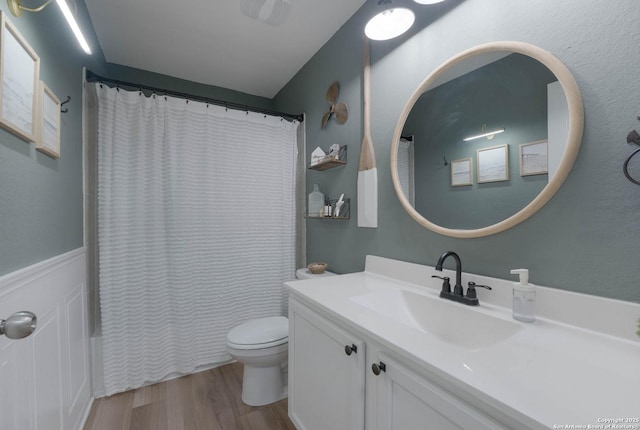 bathroom with shower / bath combo, vanity, toilet, and wood finished floors