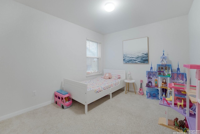 bedroom featuring carpet floors and baseboards