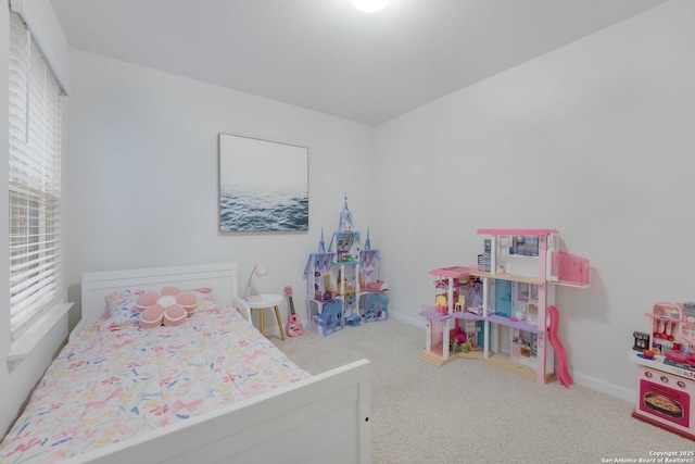 carpeted bedroom with baseboards