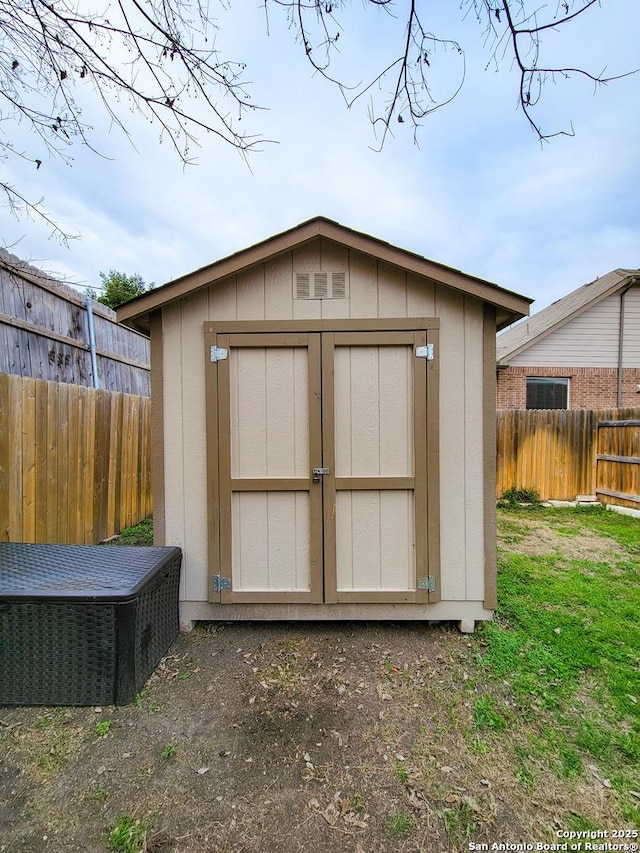 view of shed featuring fence private yard