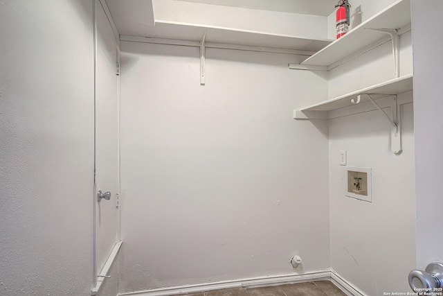 washroom featuring hookup for a washing machine, baseboards, and laundry area