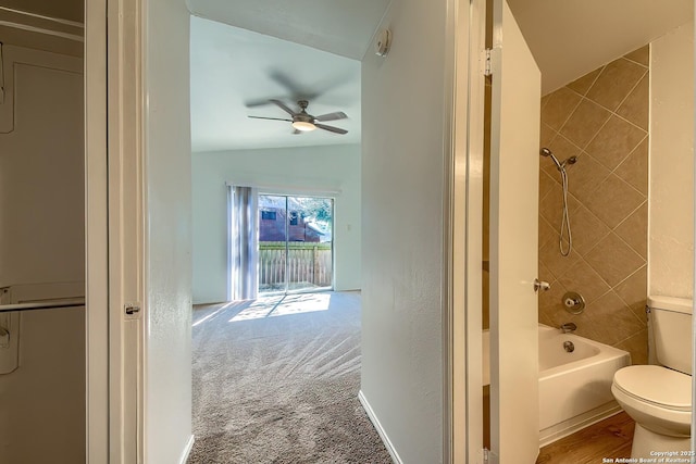 full bath with toilet, baseboards, shower / washtub combination, and lofted ceiling