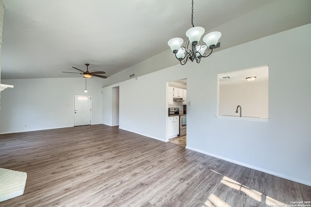 unfurnished living room featuring ceiling fan with notable chandelier, light wood-type flooring, visible vents, and baseboards