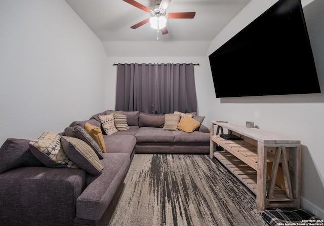 living room with vaulted ceiling, ceiling fan, and baseboards