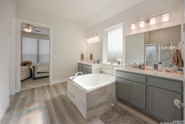 full bath with a bath, vanity, wood finished floors, and ensuite bathroom