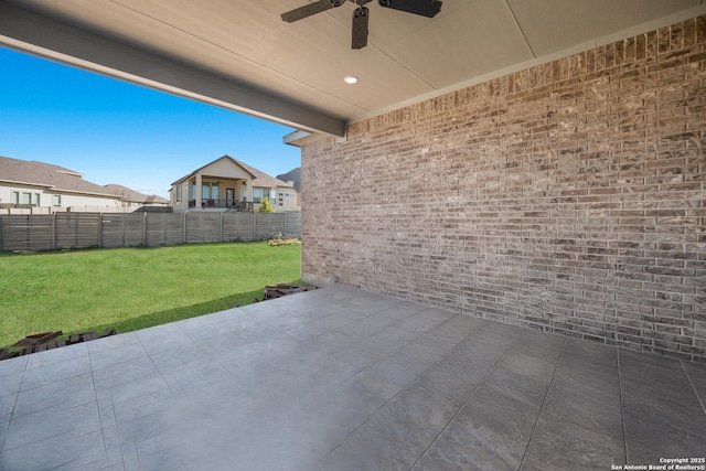 view of patio with a fenced backyard and ceiling fan