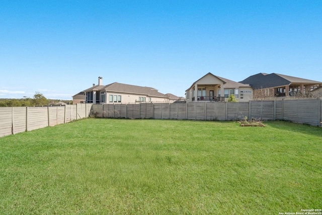 view of yard with a fenced backyard