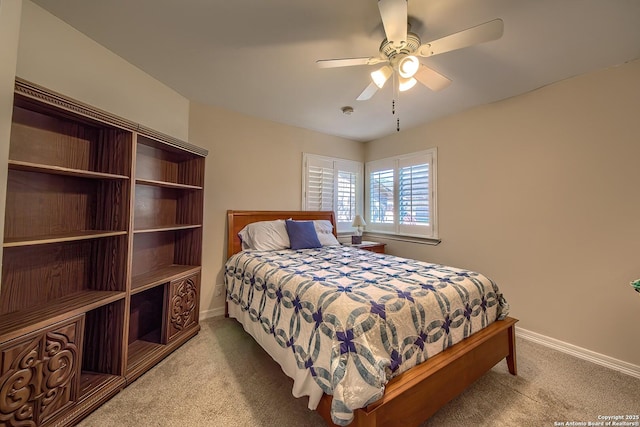 bedroom with baseboards, a ceiling fan, and light colored carpet