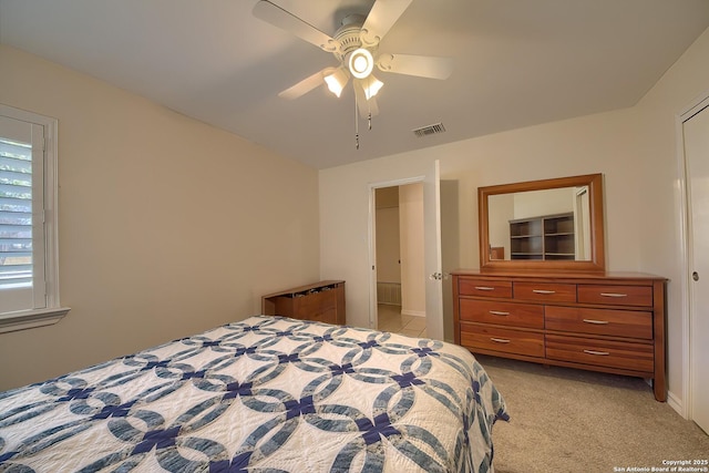 bedroom with light carpet, ceiling fan, and visible vents