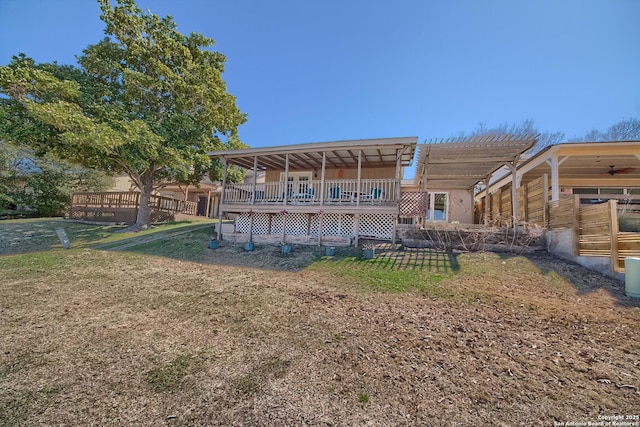 back of house with a lawn and a pergola