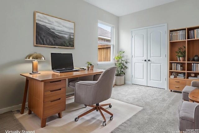 office with light carpet and baseboards