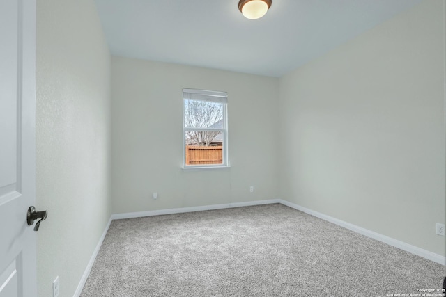 unfurnished room featuring baseboards and carpet flooring