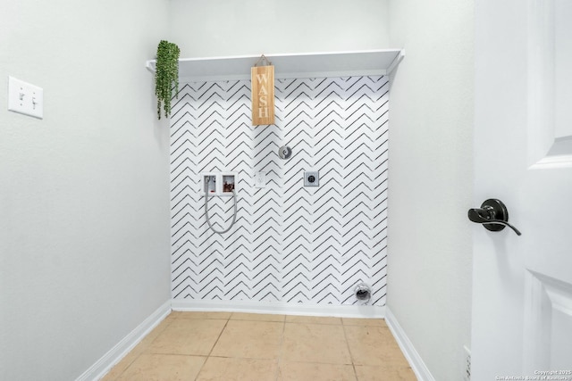 clothes washing area featuring baseboards, laundry area, electric dryer hookup, and tile patterned floors