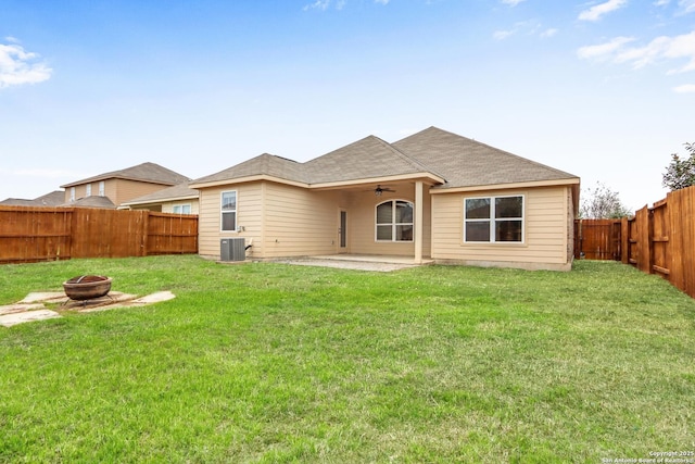 back of house featuring ceiling fan, central AC unit, an outdoor fire pit, a fenced backyard, and a patio area