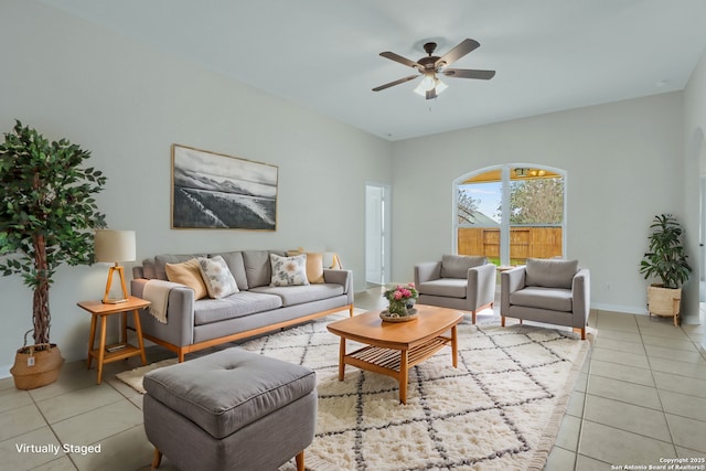 living room with light tile patterned flooring, a ceiling fan, and baseboards