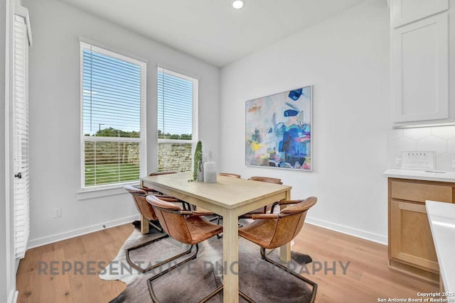 dining room featuring light wood-style floors, baseboards, and recessed lighting