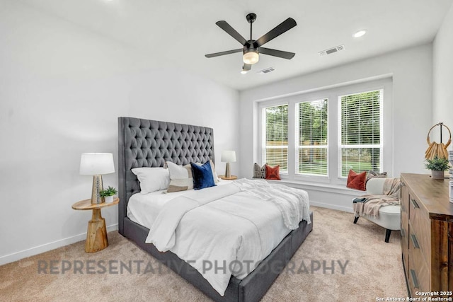 bedroom featuring light carpet, visible vents, and baseboards