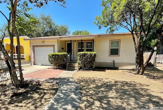 ranch-style home featuring fence and an attached garage