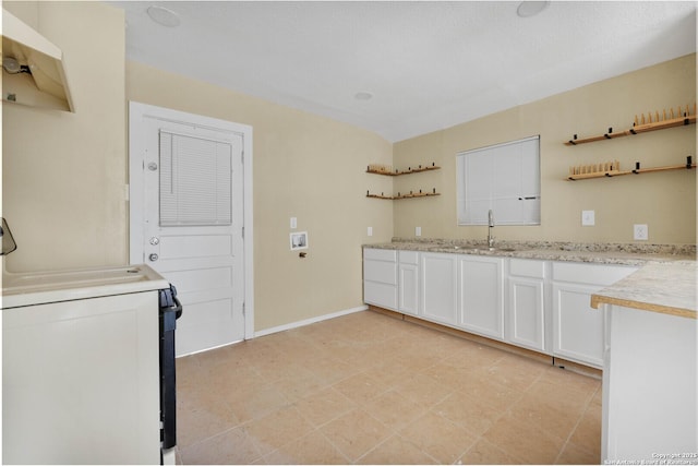 laundry room featuring a sink and baseboards