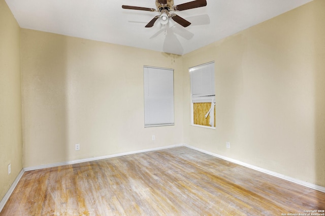 unfurnished room featuring light wood finished floors, a ceiling fan, and baseboards