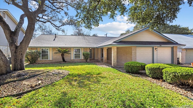 ranch-style home with a front lawn, brick siding, and an attached garage